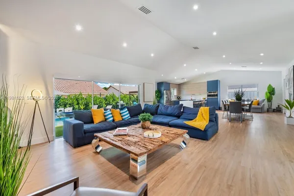 a living room with furniture fireplace and a large window
