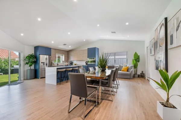 a view of a dining room with furniture and wooden floor