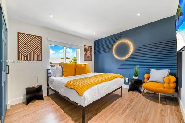 a bedroom with a bed and chair