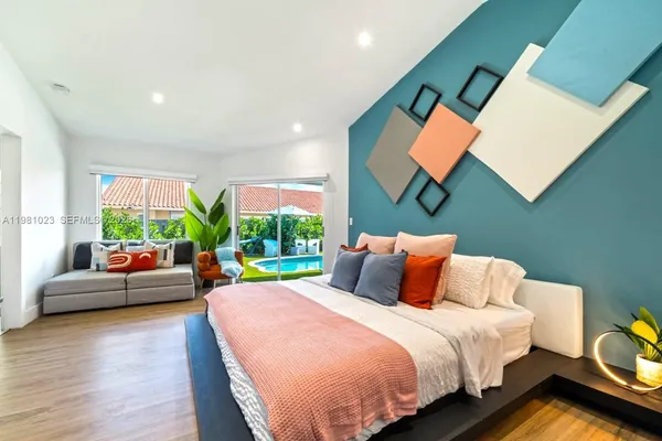 a bedroom with a bed and glass windows