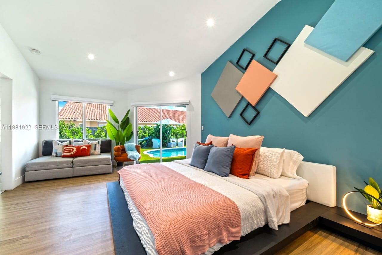 14481 Southwest 161 Street Miami, FL 33177 - Photo 20 of 24 a bedroom with a bed and glass windows