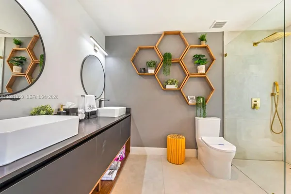a bathroom with a sink mirror and vanity