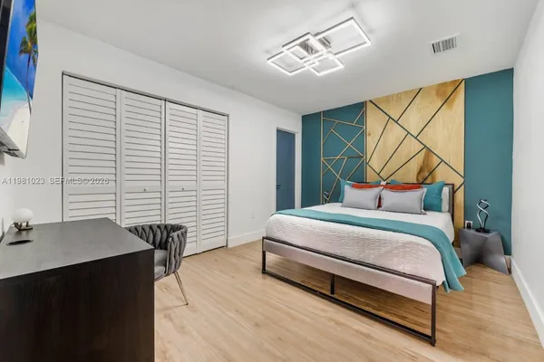 a bedroom with a bed and a table in it