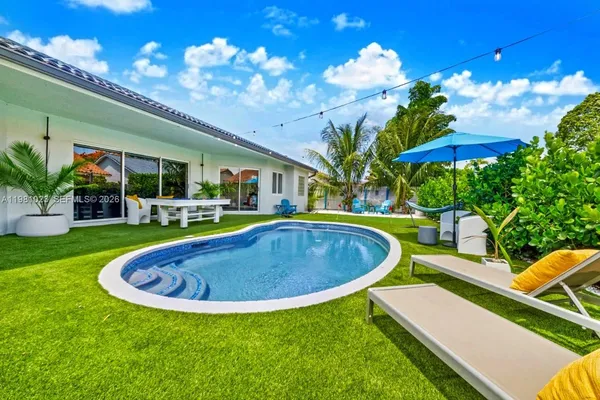 a view of swimming pool with outdoor seating