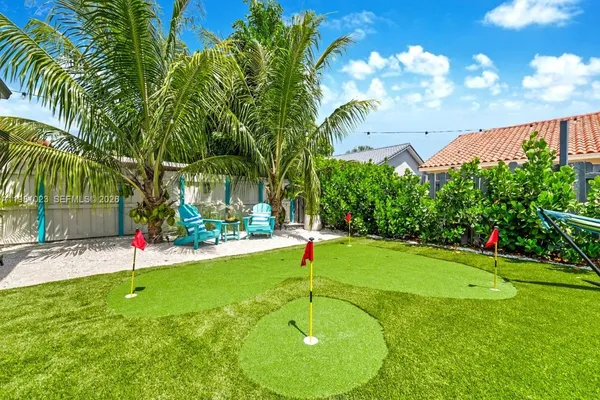 a garden with trees in front of it