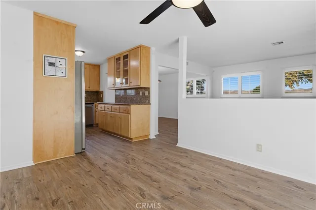 a view of a kitchen with a sink cabinets and wooden floor
