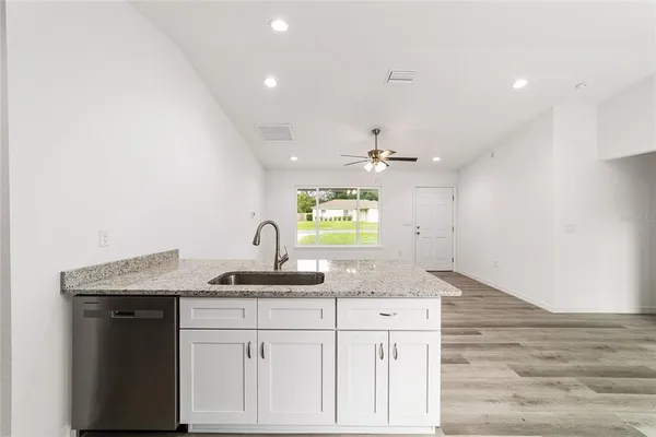 a kitchen with granite countertop white cabinets and a granite counter tops