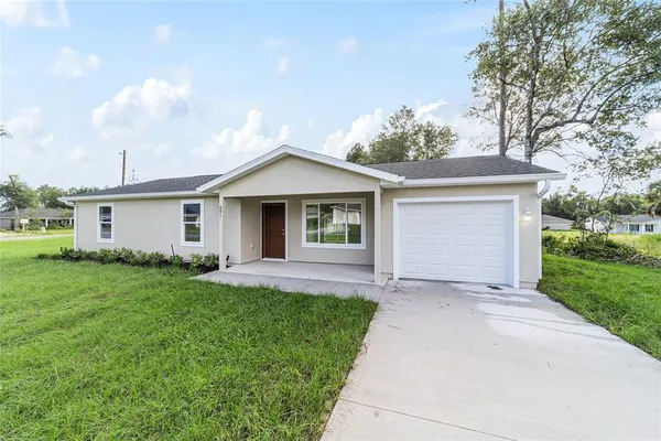 a front view of house with yard and green space