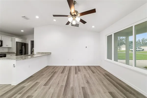 a view of kitchen with sink and wooden floor
