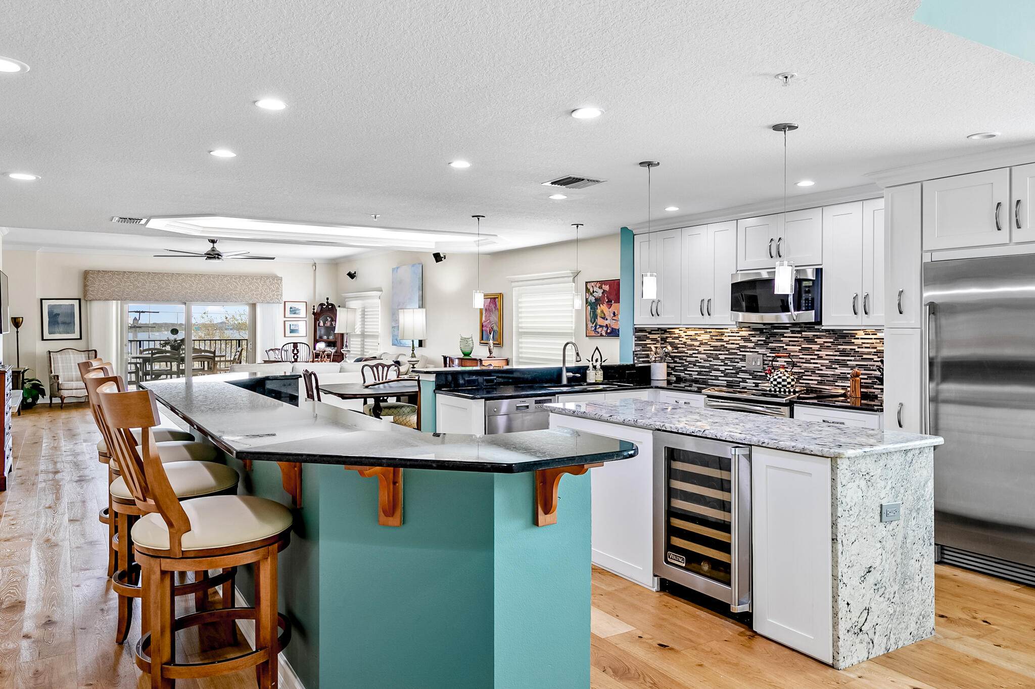 29 Riverside Drive, Unit 401 Cocoa, FL 32922 - Photo 20 of 41 a kitchen with stainless steel appliances granite countertop a table chairs and a refrigerator