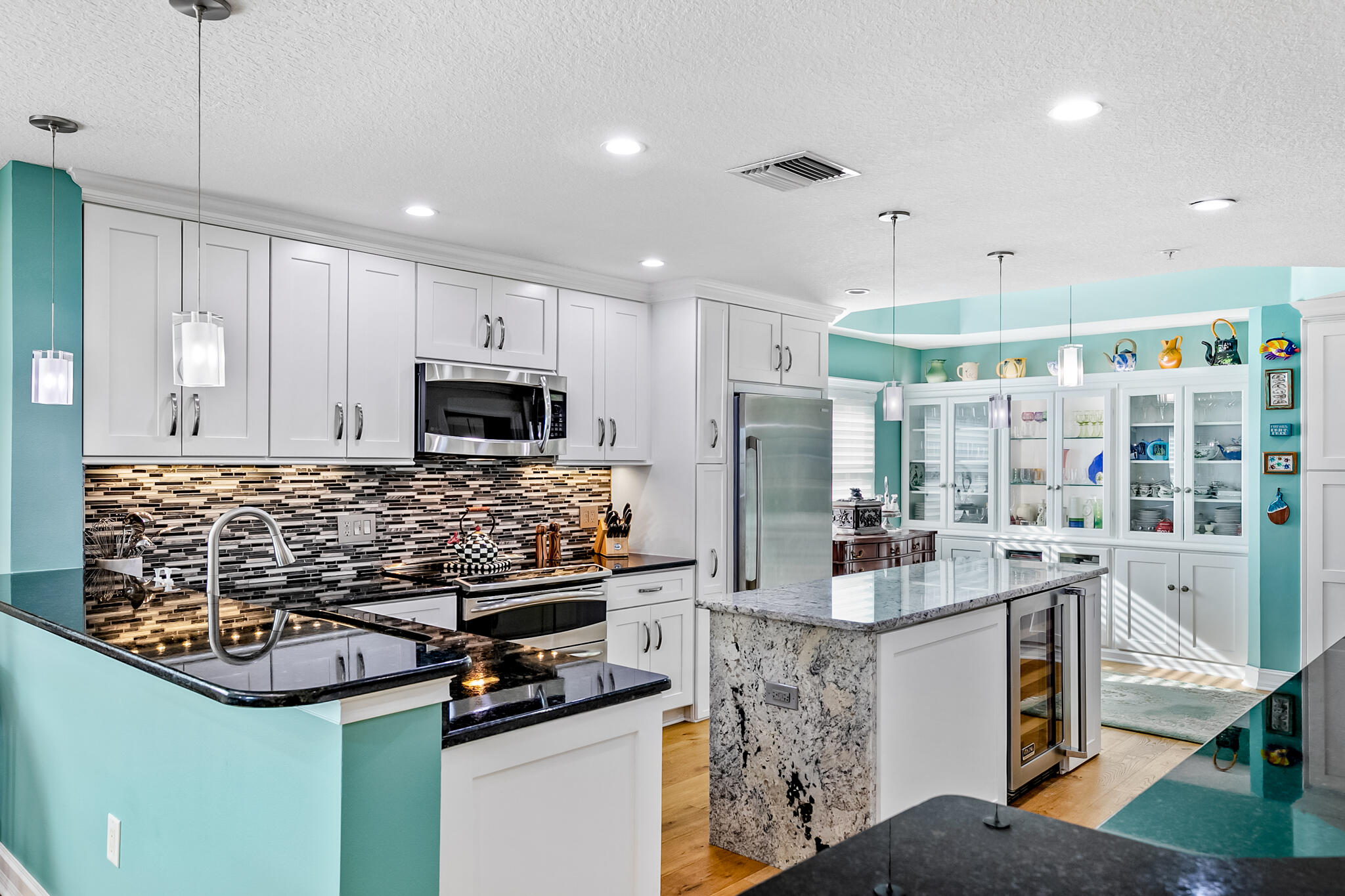 29 Riverside Drive, Unit 401 Cocoa, FL 32922 - Photo 21 of 41 a kitchen with stainless steel appliances kitchen island granite countertop a stove and a refrigerator