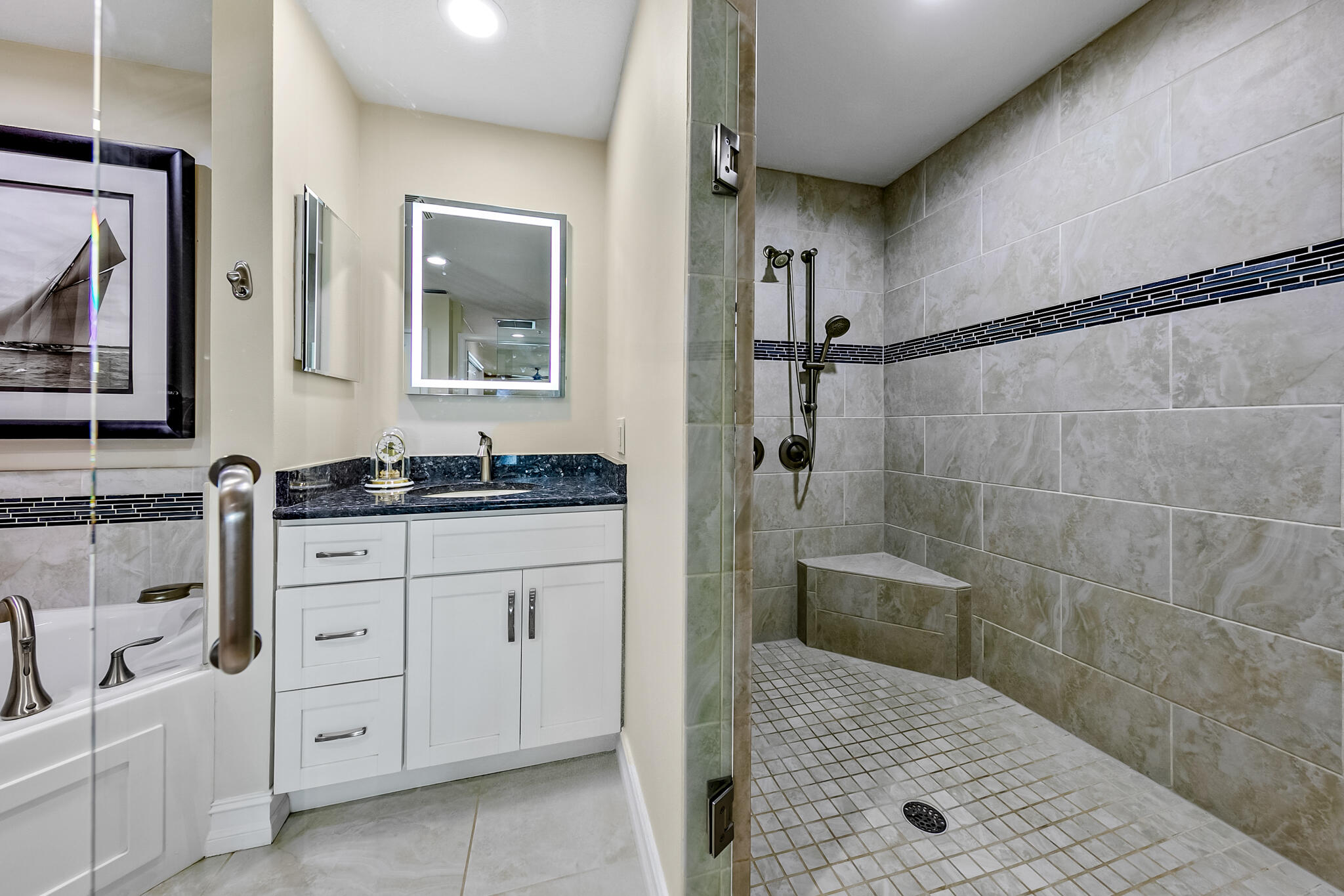 29 Riverside Drive, Unit 401 Cocoa, FL 32922 - Photo 35 of 41 a bathroom with a granite countertop sink a mirror and shower
