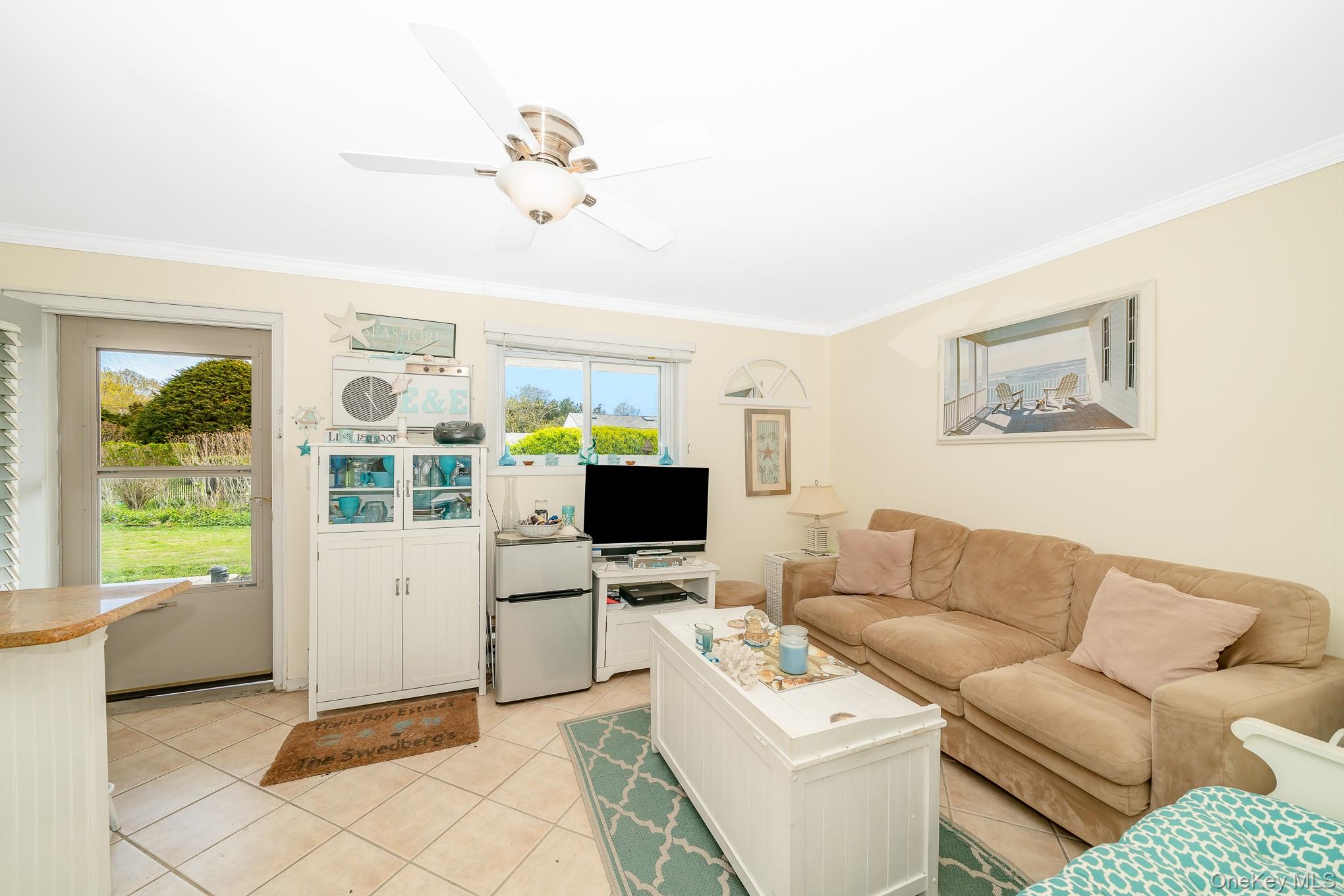 50 Rampasture Road, Unit 6 Hampton Bays, NY 11946 - Photo 22 of 35 a living room with furniture and a flat screen tv