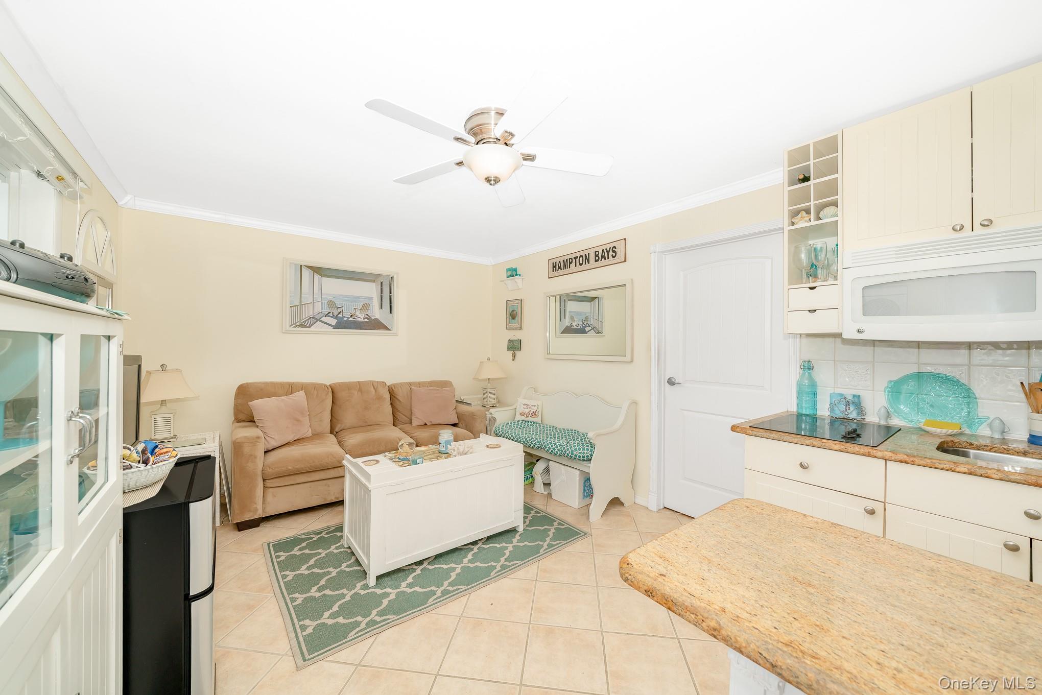 50 Rampasture Road, Unit 6 Hampton Bays, NY 11946 - Photo 24 of 35 a living room with furniture and a fireplace