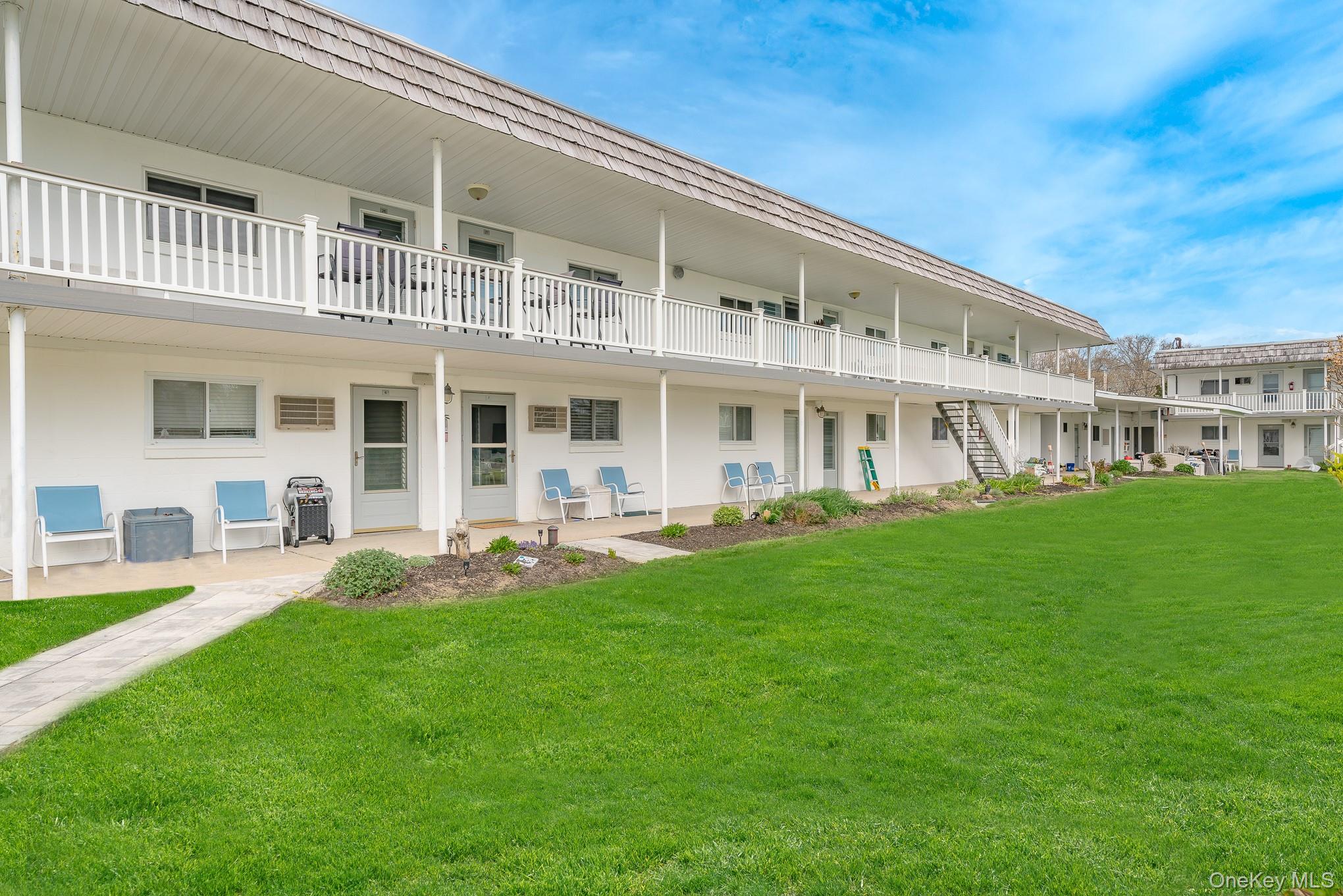 50 Rampasture Road, Unit 6 Hampton Bays, NY 11946 - Photo 35 of 35 a view of an apartment with a house in the background