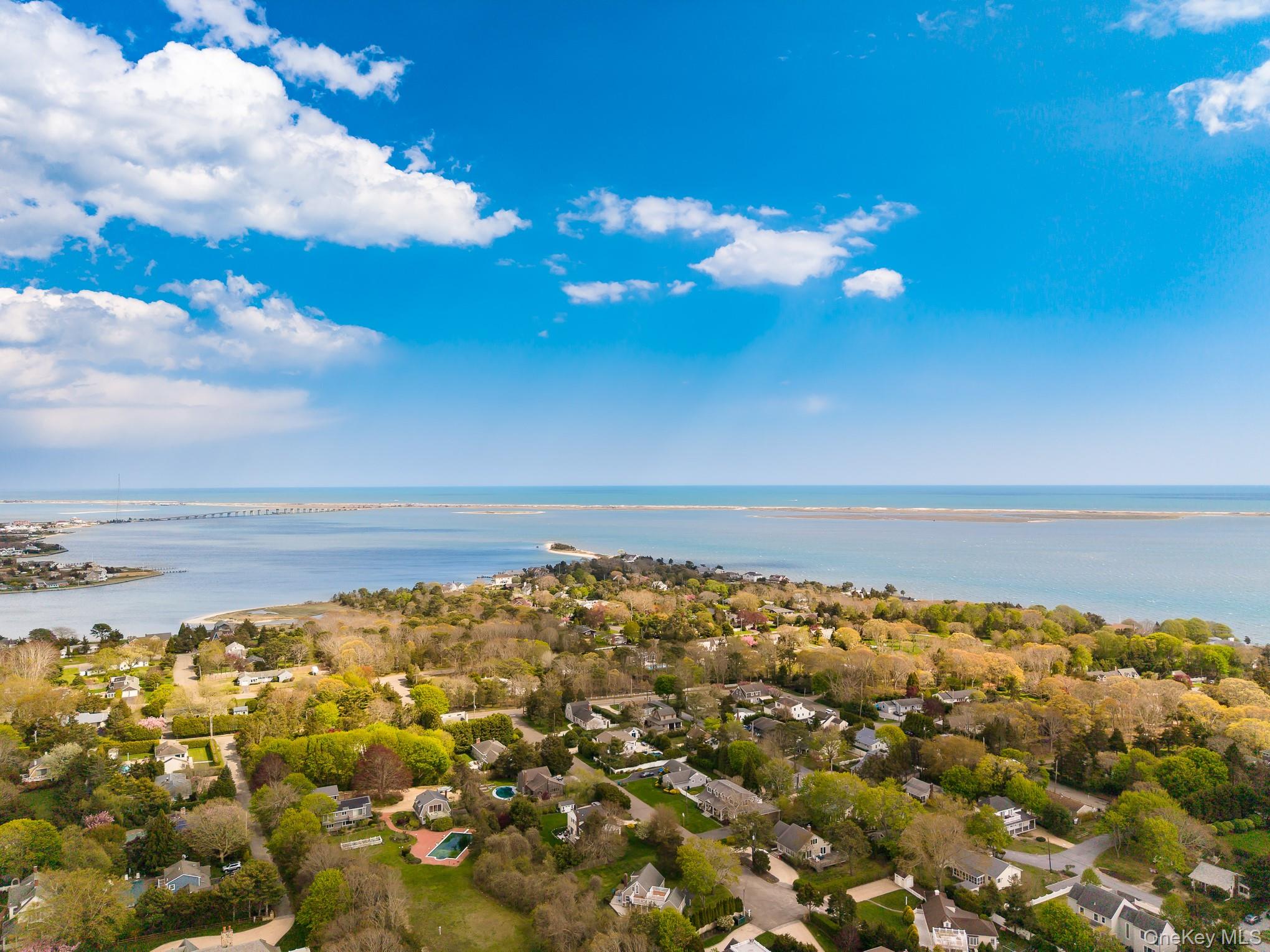 50 Rampasture Road, Unit 6 Hampton Bays, NY 11946 - Photo 5 of 35 a view of a large body of water with lots of residential buildings