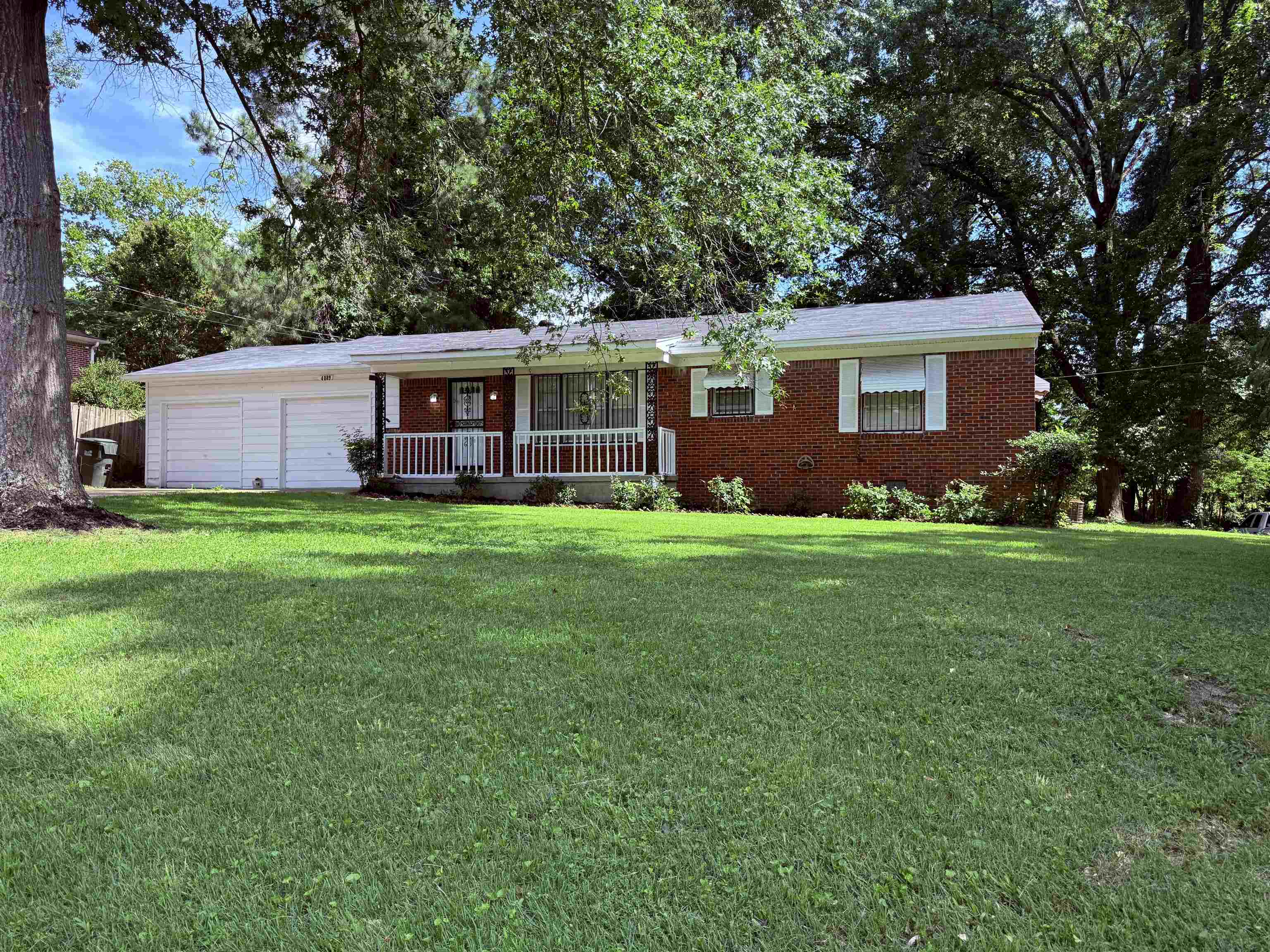 4089 Tessland Road Memphis, TN 38128 - Photo 1 of 34 Ranch-style house featuring a front yard, brick siding, an attached garage, and a porch