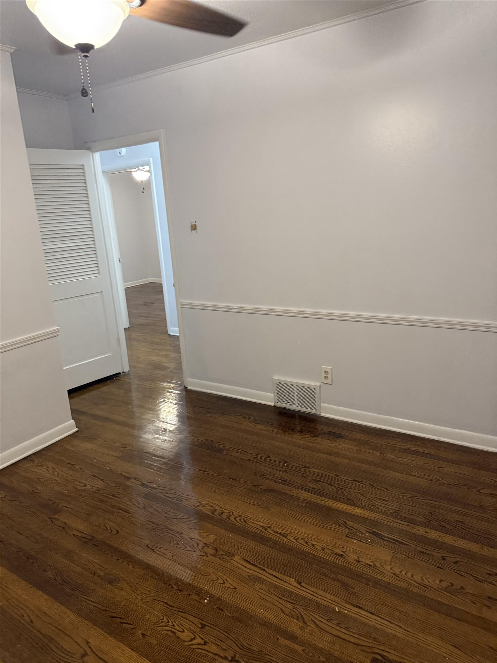 4089 Tessland Road Memphis, TN 38128 - Photo 16 of 34 Spare room featuring crown molding, dark wood-type flooring, and a ceiling fan