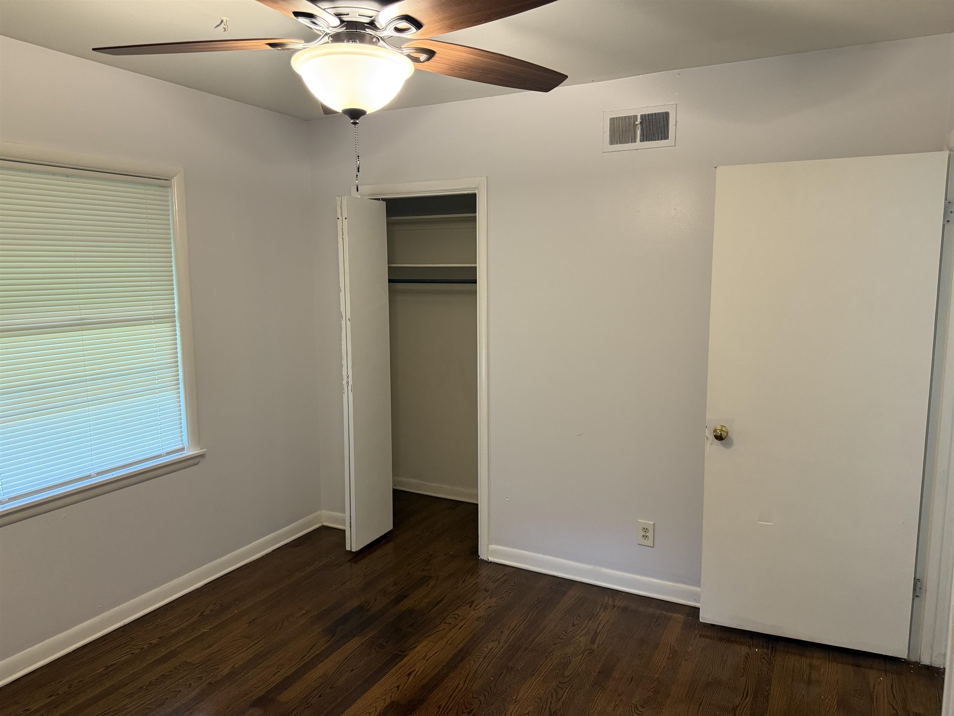 4089 Tessland Road Memphis, TN 38128 - Photo 17 of 34 Unfurnished bedroom featuring dark wood-style floors, a closet, and a ceiling fan