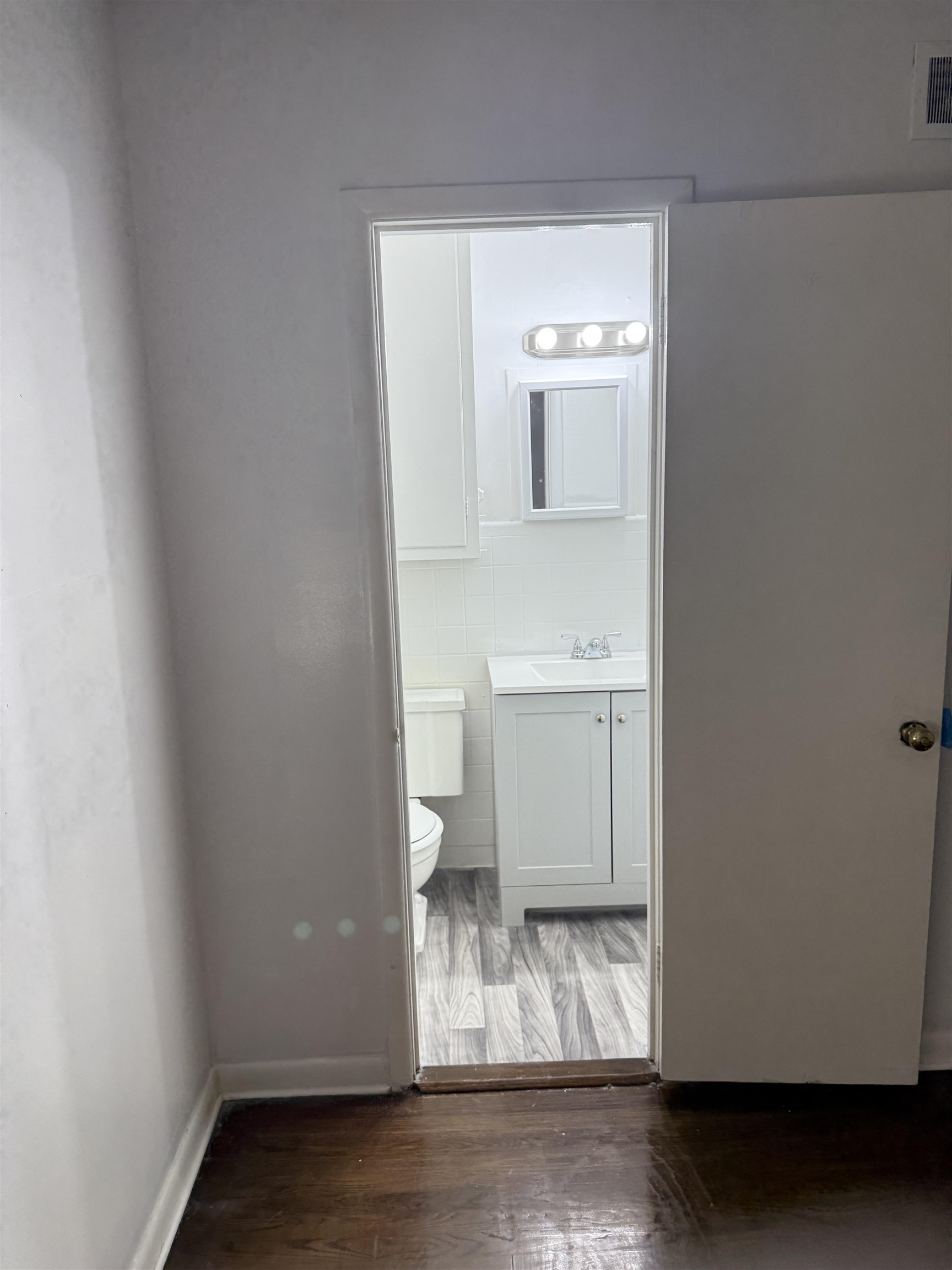 4089 Tessland Road Memphis, TN 38128 - Photo 23 of 34 Bathroom with wood finished floors, vanity, and tile walls