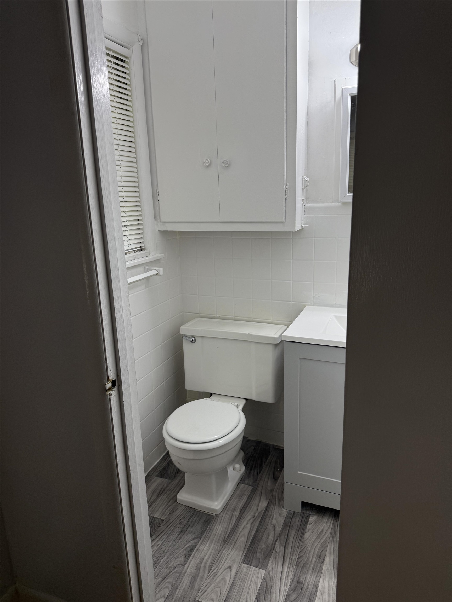 4089 Tessland Road Memphis, TN 38128 - Photo 24 of 34 Bathroom featuring vanity, shower / bath combination with glass door, tasteful backsplash, and tile walls