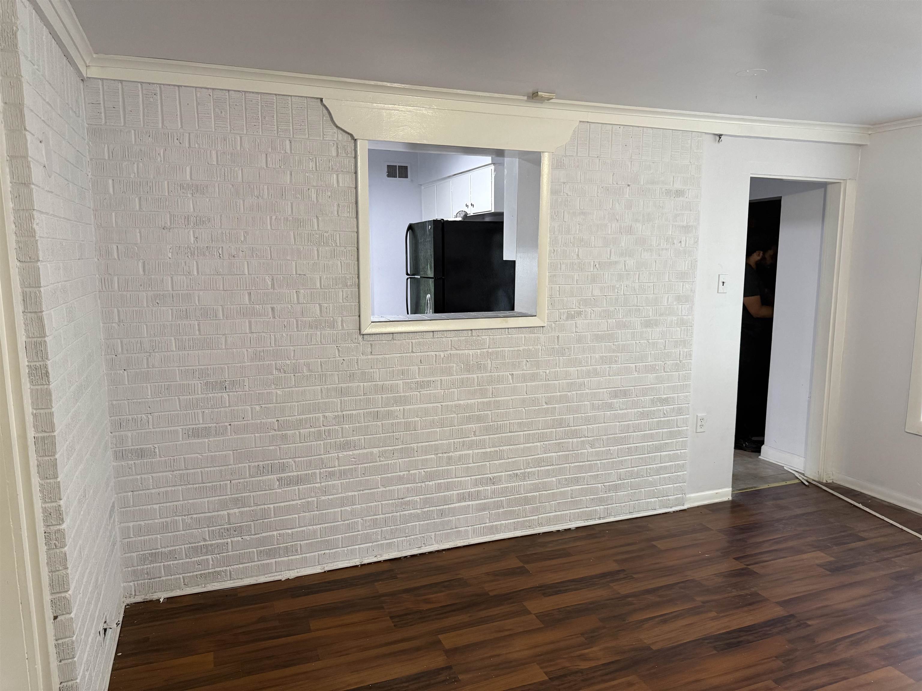 4089 Tessland Road Memphis, TN 38128 - Photo 27 of 34 Unfurnished room featuring ornamental molding, wood finished floors, and brick wall