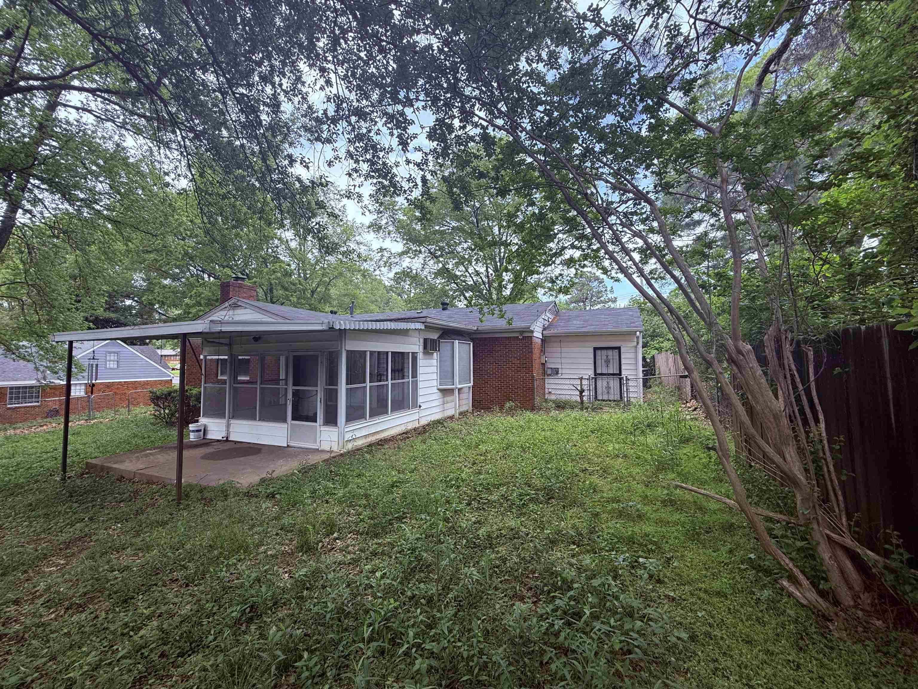 4089 Tessland Road Memphis, TN 38128 - Photo 5 of 34 Rear view of property with a sunroom, a chimney, and a patio area