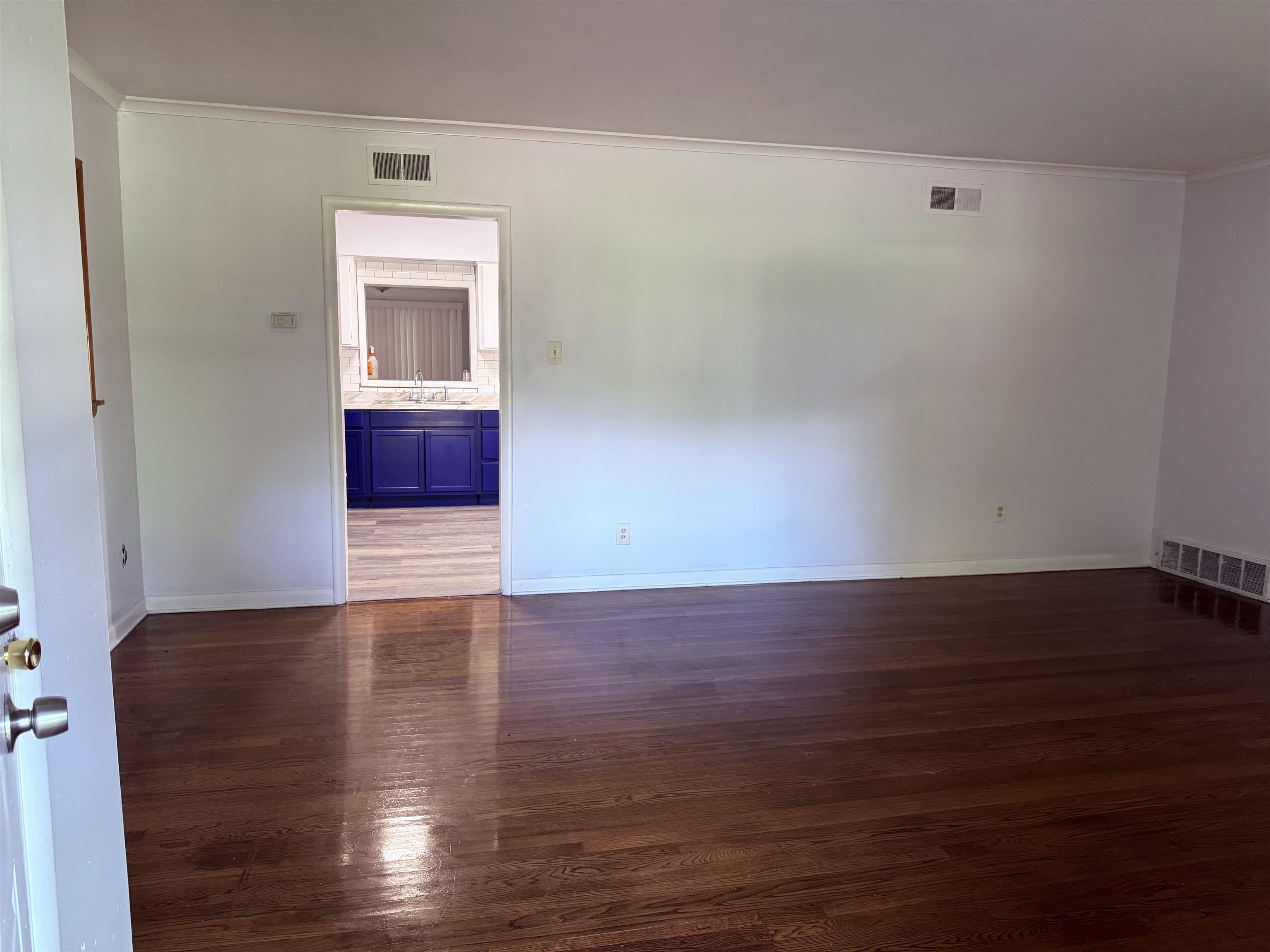 4089 Tessland Road Memphis, TN 38128 - Photo 9 of 34 Spare room with crown molding and dark wood-style floors