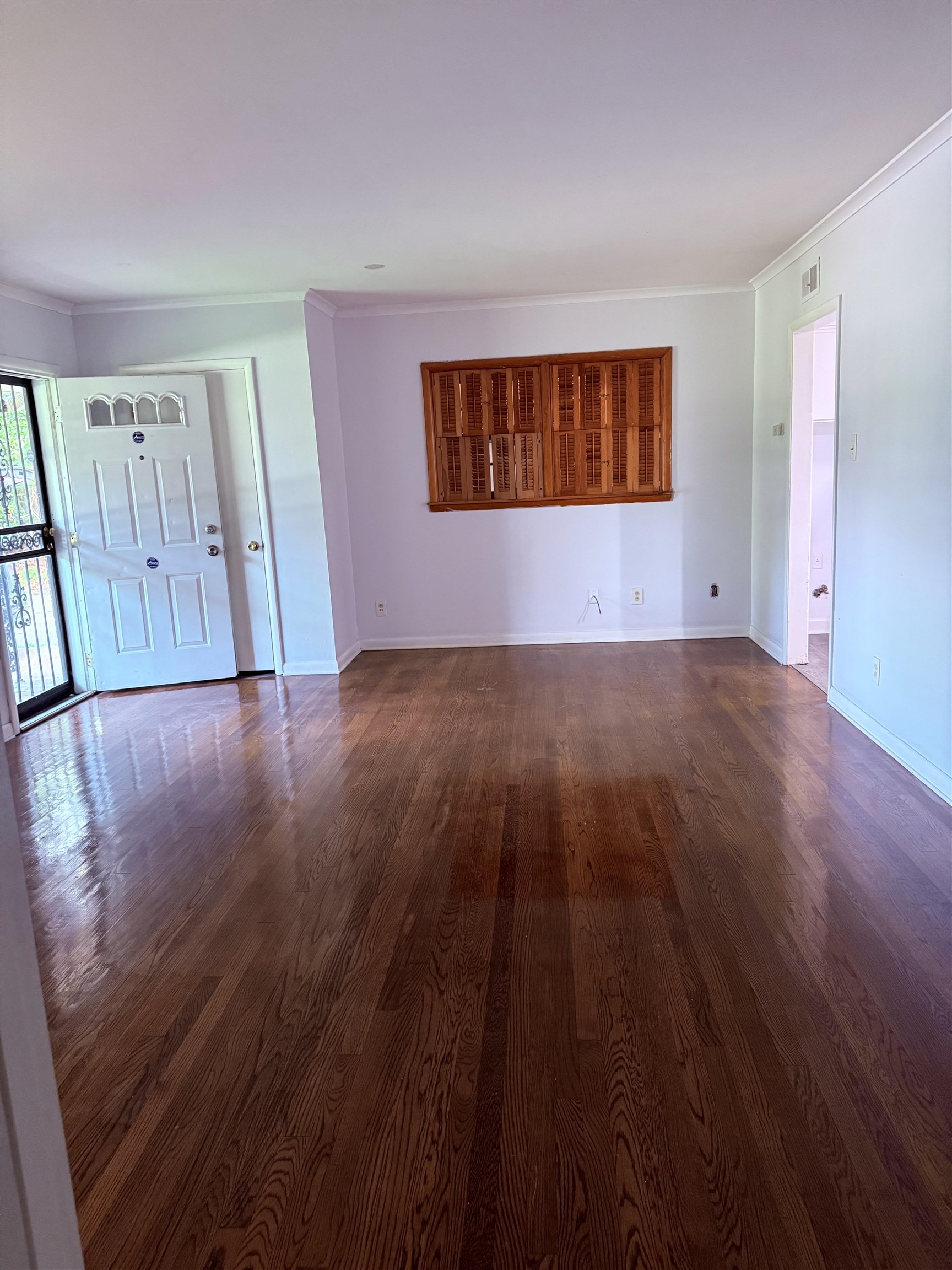 4089 Tessland Road Memphis, TN 38128 - Photo 10 of 34 Unfurnished living room with crown molding and dark wood-style floors