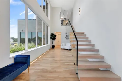 a view of entryway and hall with wooden floor