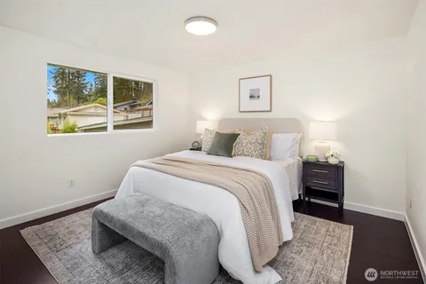 a bedroom with a bed and a lamp with window