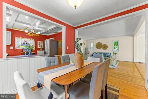 a dining room with furniture and wooden floor