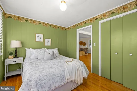 a bedroom with a bed and a mirror