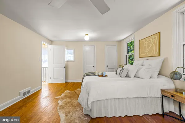 a spacious bedroom with a bed and a window