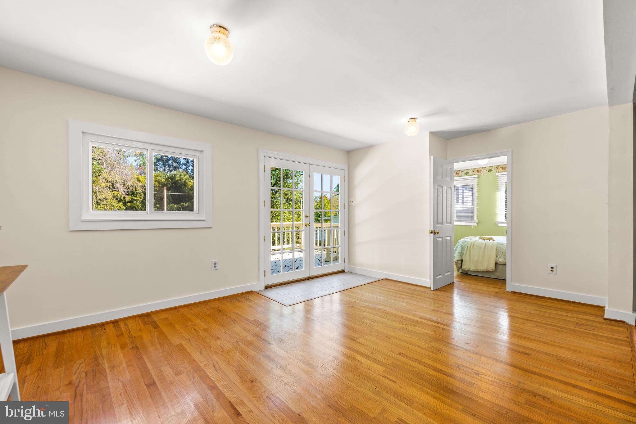 2926 Placid Avenue Baltimore, MD 21234 - Photo 10 of 37 a view of an empty room with glass door and wooden floor