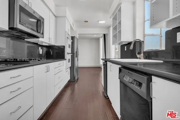 a kitchen with stainless steel appliances granite countertop a stove and a refrigerator