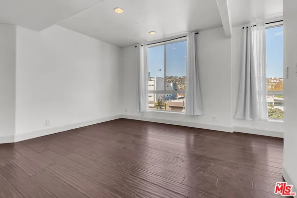 a bathroom with a granite countertop toilet sink and mirror