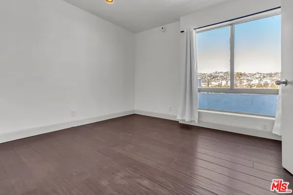 an empty room with wooden floor