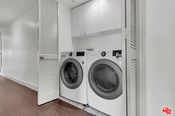 a bathroom with a tub sink shower and mirror