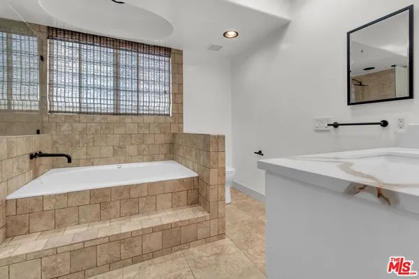 a bathroom with a toilet and shower