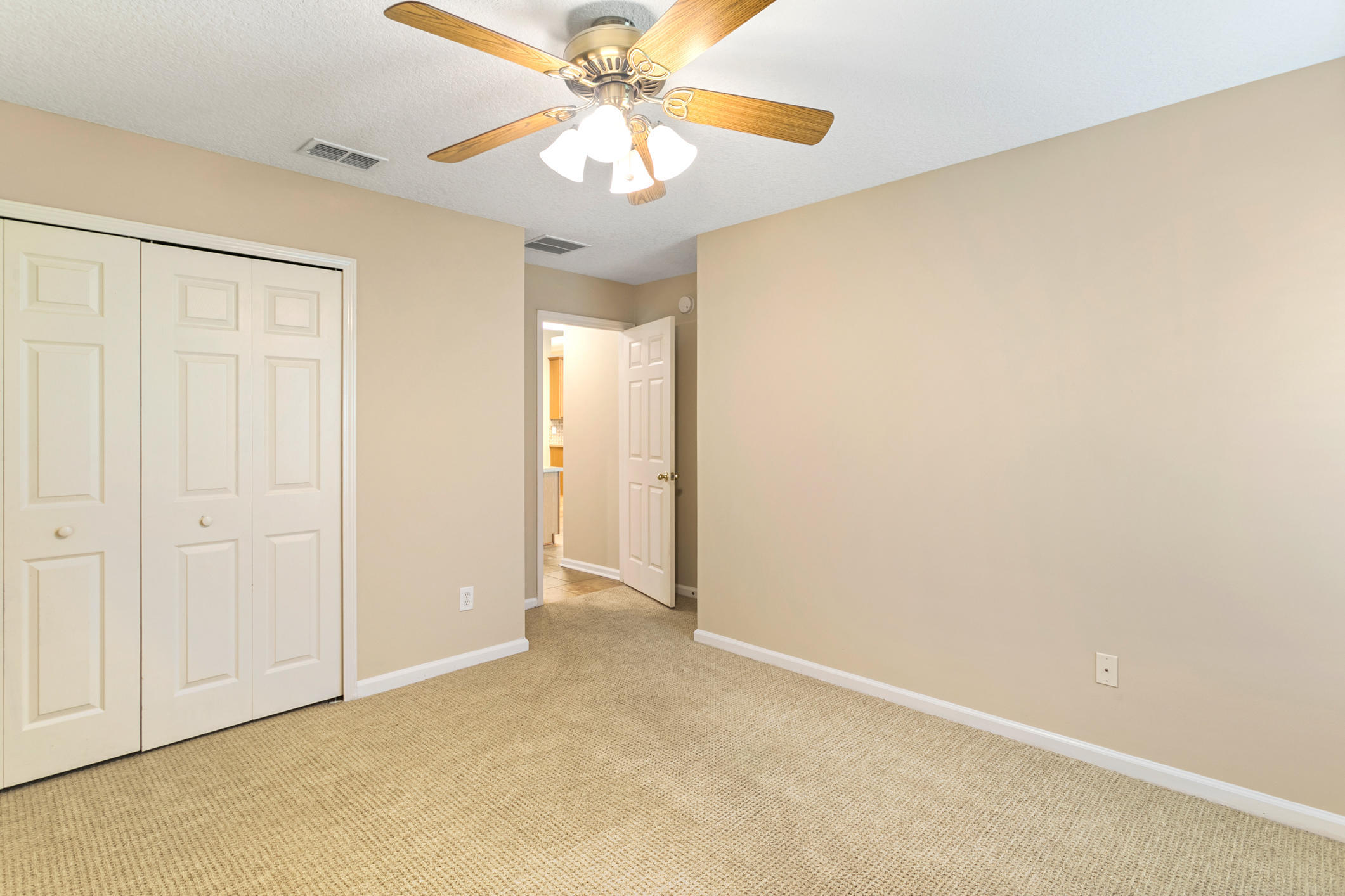 1277 Ribbon Road St. Johns, FL 32259 - Photo 27 of 44 an empty room with a chandelier fan and windows