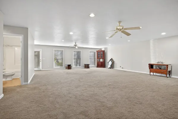 a view of a livingroom with a furniture and a ceiling fan