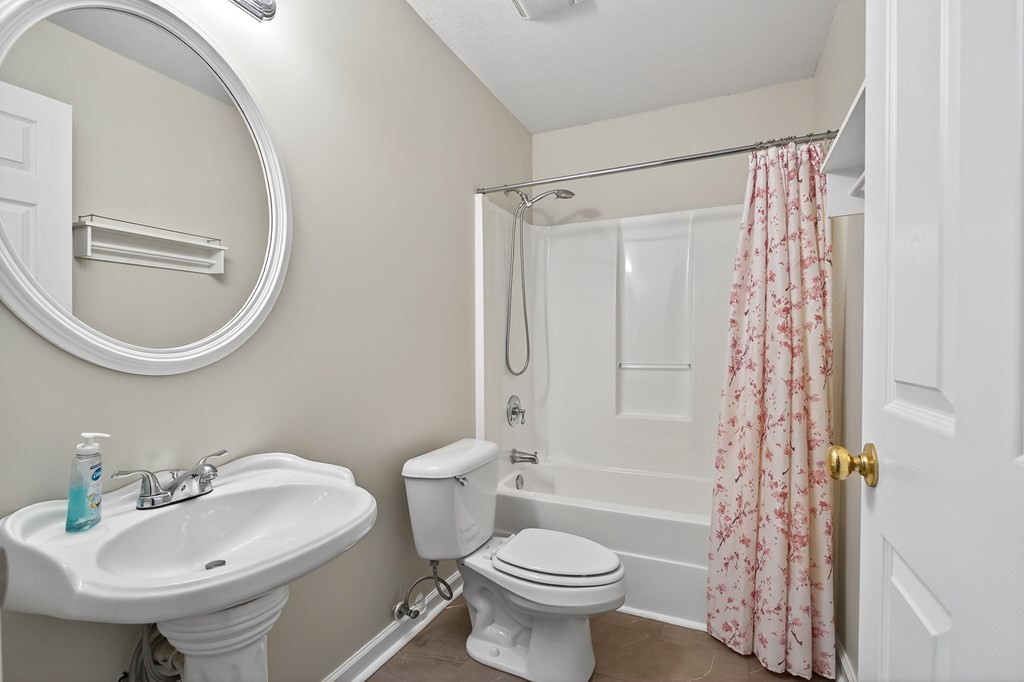 1325 Bridle Path Cookeville, TN 38501 - Photo 32 of 41 a bathroom with a sink toilet a mirror and shower