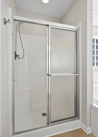 a bathroom with a glass shower door