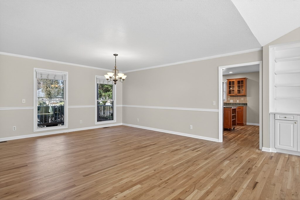 1325 Bridle Path Cookeville, TN 38501 - Photo 9 of 41 an empty room with wooden floor cabinet and windows