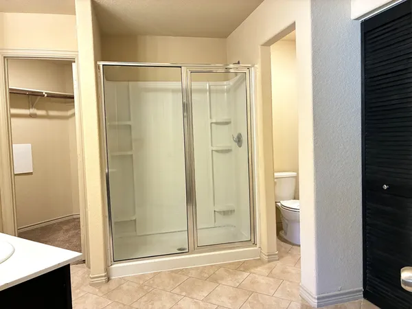 a bathroom with a glass shower door