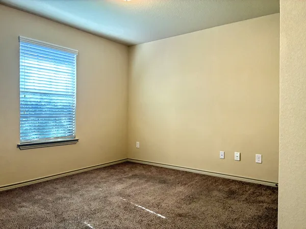 a view of an empty room and a window