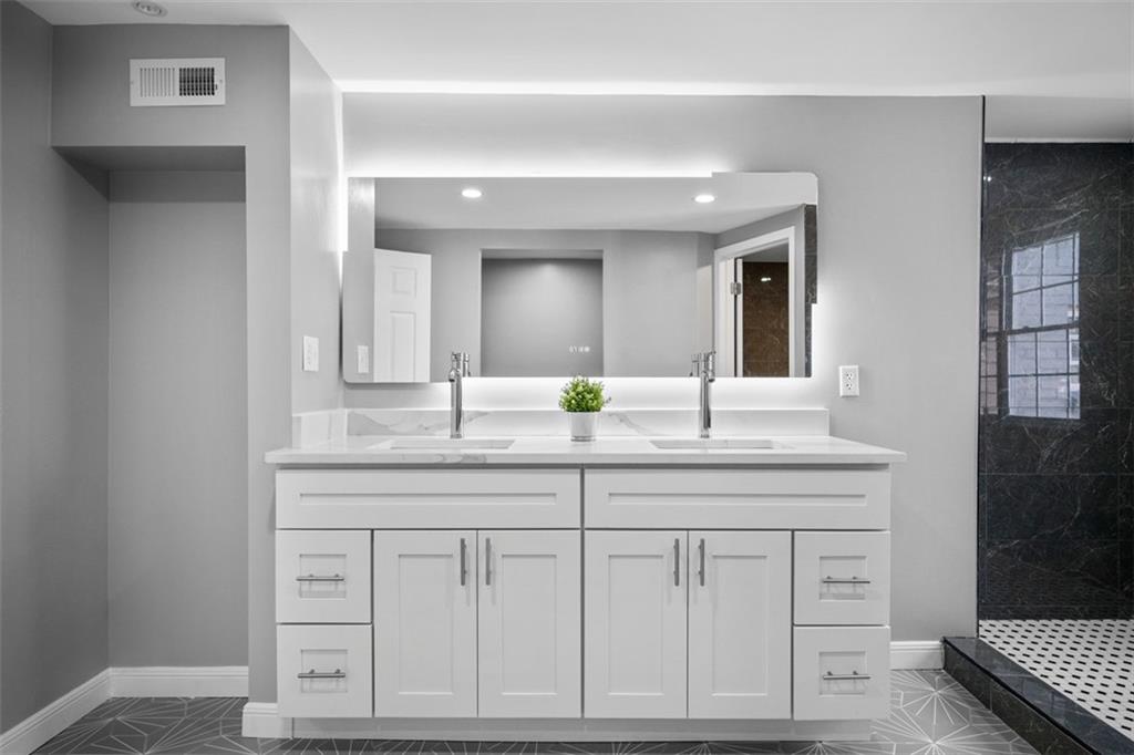 3943 Howley Street Pittsburgh, PA 15224 - Photo 12 of 32 a bathroom with a granite countertop sink and a mirror