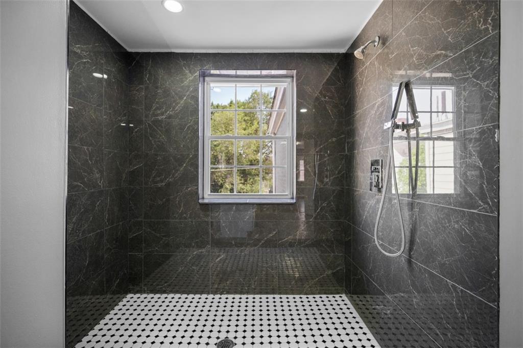 3943 Howley Street Pittsburgh, PA 15224 - Photo 13 of 32 a bathroom with a glass door shower