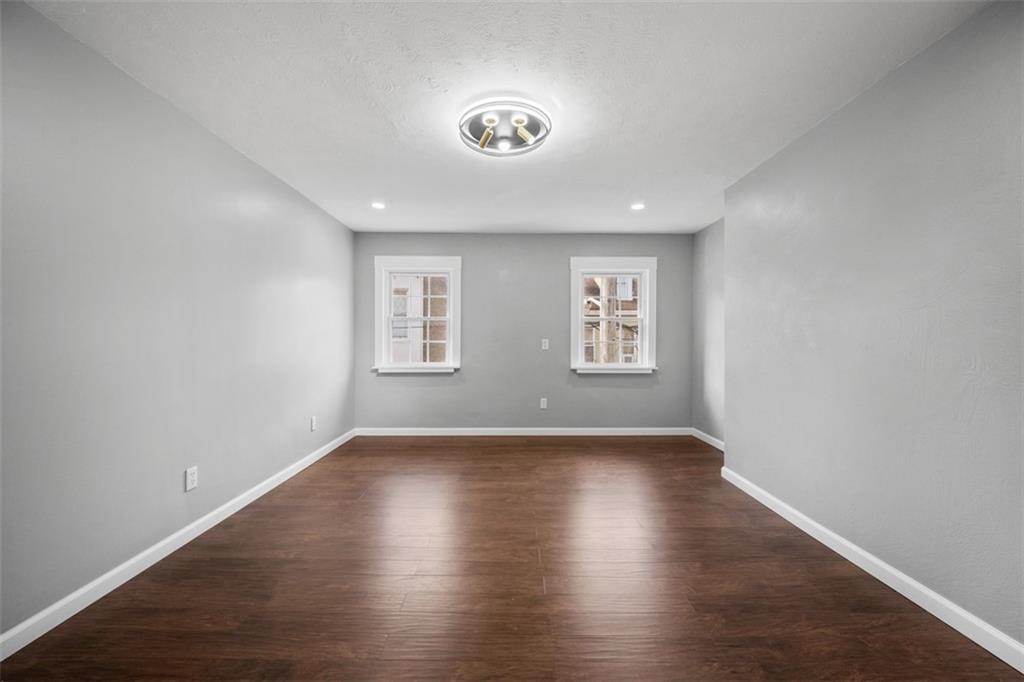 3943 Howley Street Pittsburgh, PA 15224 - Photo 15 of 32 a view of an empty room with wooden floor and a window
